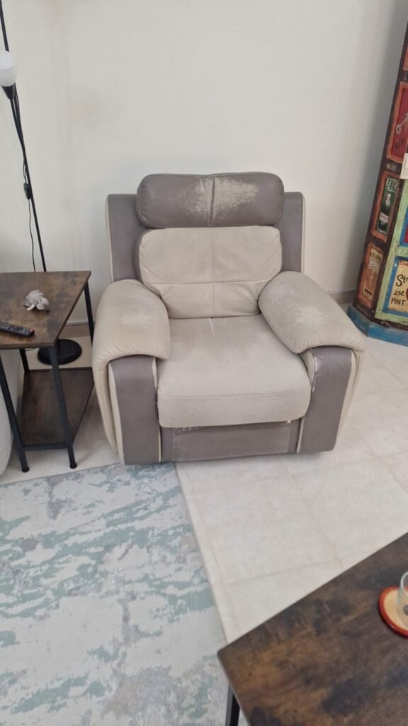 Torn and damaged sofa before repair in Dubai