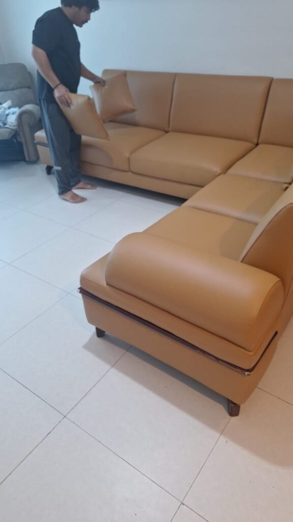 Tan leather sofa with chaise lounge showcasing sofa repair and upholstery work